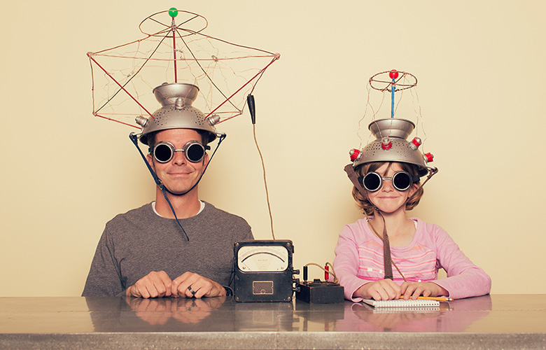 A man and a Child Wearing Scientific Head Gear
